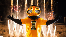Herky the Hawk standing in front of pyrotechnics